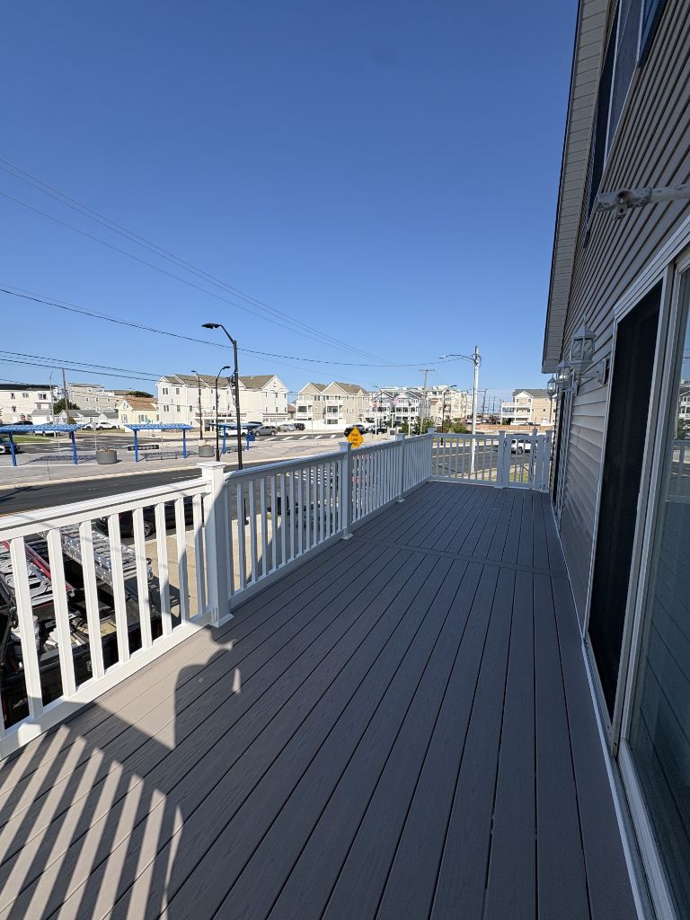 Gray composite deck with white railing at beach house — Shore NJ