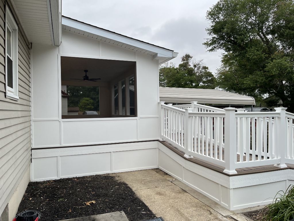 Screened porch exterior with composite deck and white railing