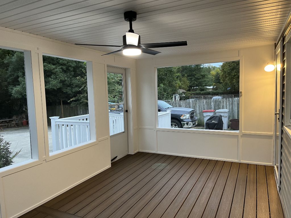 Screened porch interior with ceiling fan, composite floor and windows
