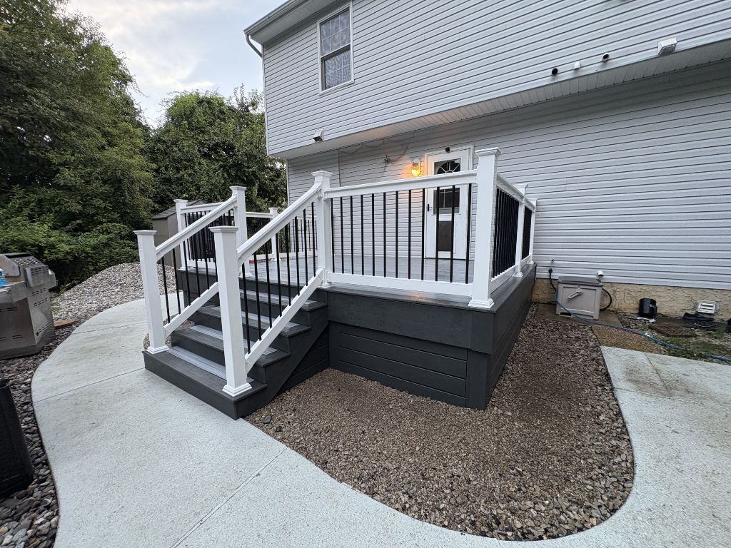 Charcoal composite deck with corner stairs and gravel border
