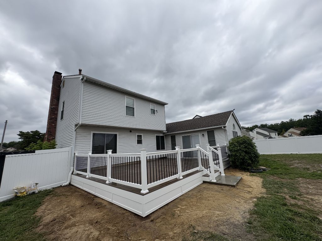 Composite deck with white railing and black balusters on South Jersey home