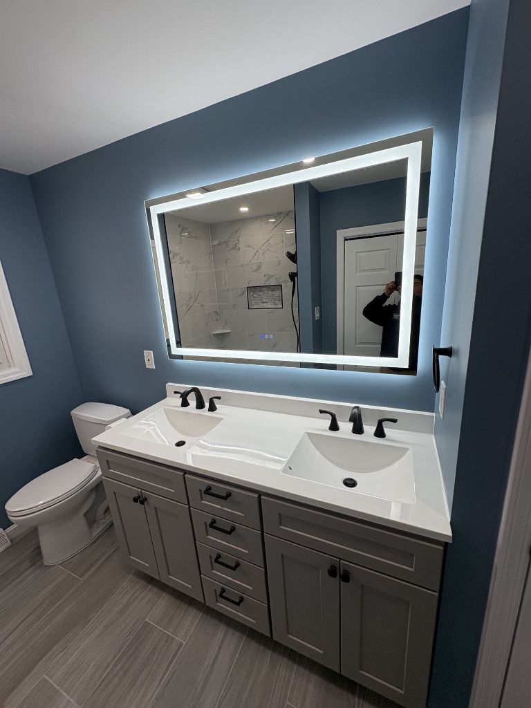 Bathroom remodel with double vanity, LED mirror and blue accent walls