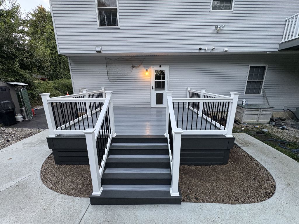 Gray composite deck with white posts and black railing — South Jersey