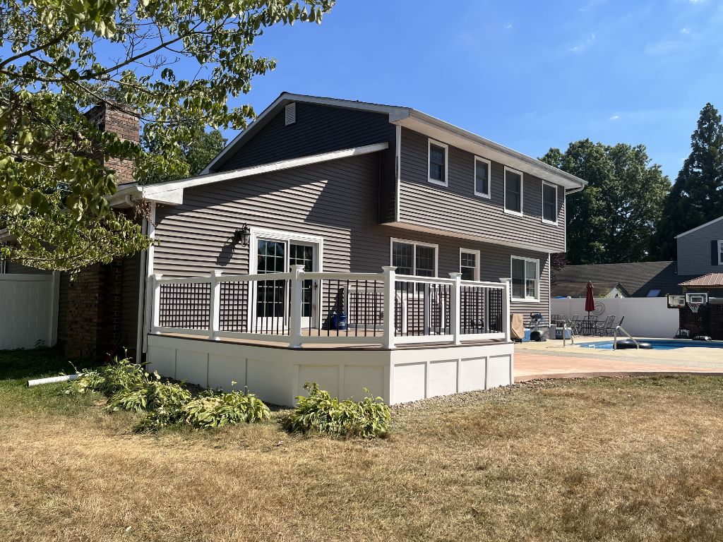 Custom deck with white railing and pool — AMG Contractors South Jersey