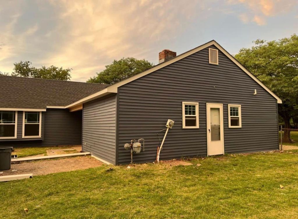 Dark navy vinyl siding on gable side elevation